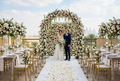 Stunning wedding floral arrangements with flower wall and bridal bouquet