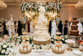 Elegant multi-tier wedding cake and dessert table